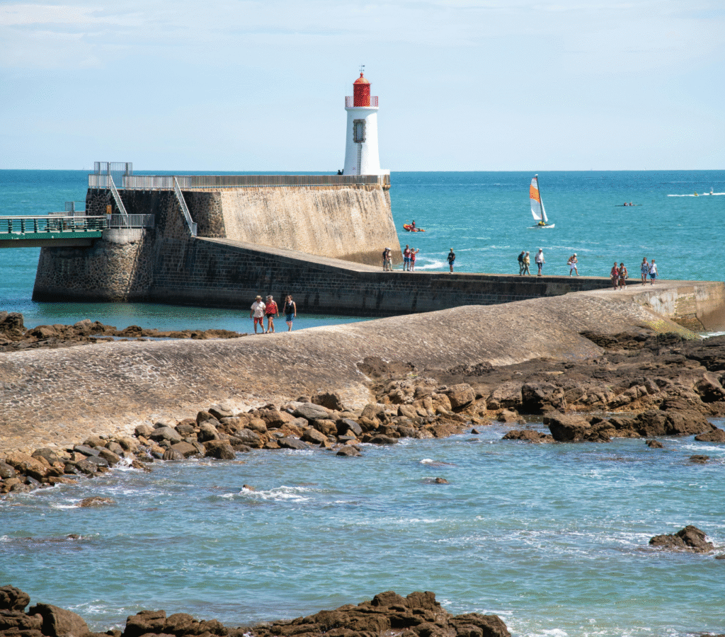 Phare rouge Saint-Nicolas sur la grande jetée des Sables-d’Olonne, symbole du littoral vendéen et de la gestion des locations Airbnb et Booking avec Embruns Vendéens